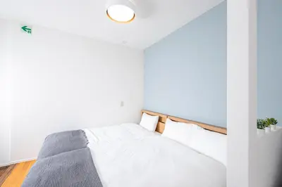 a bedroom with a bed with white walls at Japan Tokyo Ueno Ikebukuro private house 5Ppl 3Bed 37m2 for Family in Tokyo