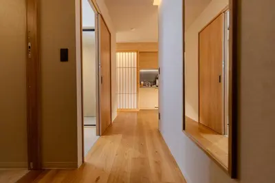 a hallway with a mirror on the wall at Racto Hotel Ikebukuro \u697d\u9014\u30db\u30c6\u30eb \u6c60\u888b in Tokyo