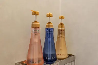 three different colored bottles sitting on a shelf at Racto Hotel Ikebukuro \u697d\u9014\u30db\u30c6\u30eb \u6c60\u888b in Tokyo