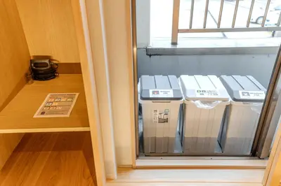 a glass door with three machines in a room at Racto Hotel Ikebukuro \u697d\u9014\u30db\u30c6\u30eb \u6c60\u888b in Tokyo