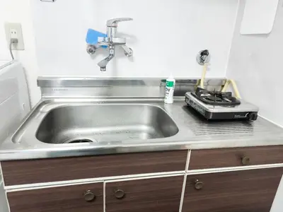 a kitchen counter with a sink and a stove at Shinjuku Tokyo \u6771\u4eac\u65b0\u5bbf SS in Wada