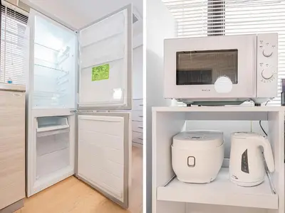a kitchen with white appliances and a refrigerator at Tawaramachi Stay 2 minutes' walk from Tawaramachi Station and 10 minutes' walk from Asakusa Station in Tokyo