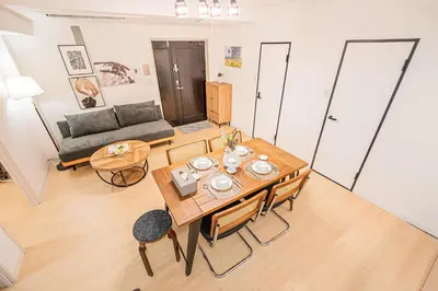 a living room with a table and a couch at Tawaramachi Stay 2 minutes' walk from Tawaramachi Station and 10 minutes' walk from Asakusa Station in Tokyo