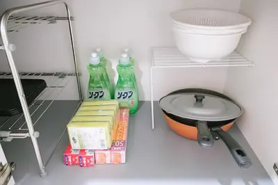 a kitchen with a counter with a sink and soda bottles at 15minutes walk from Skytree -Mukojima House- in Tokyo
