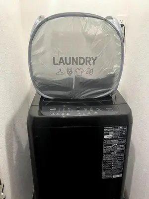 a glass case on top of a laundry machine at Met\u539f\u753a1\u4e01\u76ee in Tokyo
