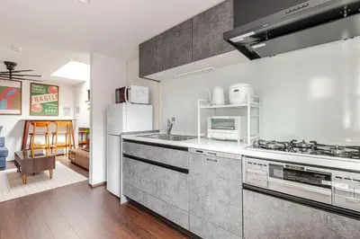 a kitchen with a stove and a refrigerator at Met\u539f\u753a1\u4e01\u76ee in Tokyo