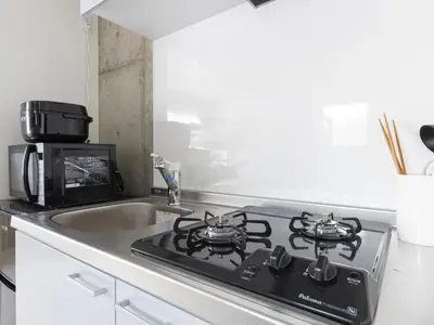 a kitchen with a stove top oven next to a sink at Tokyo Oji Apartment 3B in Tokyo