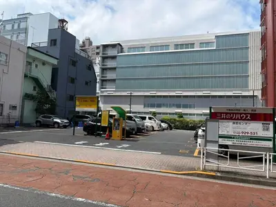 a parking lot with cars parked in front of a building at Tokyo Oji Apartment 3B in Tokyo