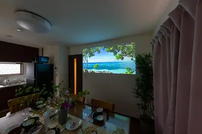 a dining room table with a view of the ocean at Kameari House Serene Japanese-Inspired Stay in Residential Tokyo in Tokyo