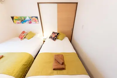 two beds sitting next to each other in a room at Kameari House Serene Japanese-Inspired Stay in Residential Tokyo in Tokyo