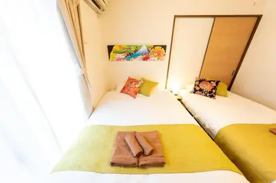 a bedroom with two beds with towels on them at Kameari House Serene Japanese-Inspired Stay in Residential Tokyo in Tokyo