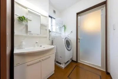 a bathroom with a sink and a washing machine at Kameari House Serene Japanese-Inspired Stay in Residential Tokyo in Tokyo