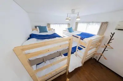 two bunk beds in a white room with windows at 12min walk from Ikebukuro Station Max 15 people in Tokyo