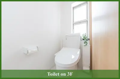 a white bathroom with a toilet and a window at 12min walk from Ikebukuro Station Max 15 people in Tokyo