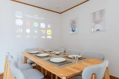 a dining room with a wooden table and chairs at 12min walk from Ikebukuro Station Max 15 people in Tokyo
