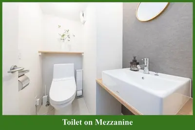 a bathroom with a white toilet and a sink at Direct to Asakusa Ginza & NRT HND 2025 New House in Tokyo