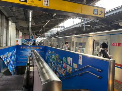 a subway station with people on a subway train at Direct to Asakusa Ginza & NRT HND 2025 New House in Tokyo