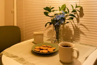a table with a plate of cookies and a cup of coffee at THE CAMINO Nakano 302 in Tokyo