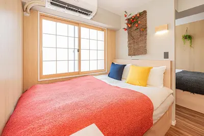 a bedroom with a large bed and a window at Komorebi Asakusa Cozy 4P Stay The 77 House Tokyo in Tokyo