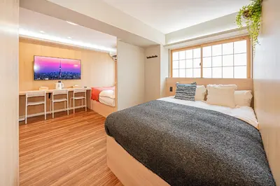 a bedroom with a bed and a desk and a television at Komorebi Asakusa Cozy 4P Stay The 77 House Tokyo in Tokyo