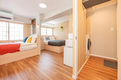 a small bedroom with two beds and a couch at Komorebi Asakusa Cozy 4P Stay The 77 House Tokyo in Tokyo