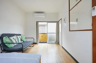 a hospital room with a couch and a window at Sweet House\u6771\u6c60\u888b in Tokyo