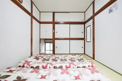 a bedroom with a bed with pink flowers on it at Sweet House\u6771\u6c60\u888b in Tokyo