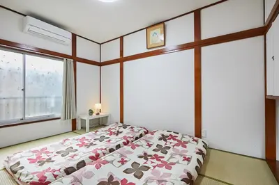 a bedroom with a bed and a large window at Sweet House\u6771\u6c60\u888b in Tokyo