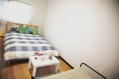 a small bedroom with a bed and a table at Sweet House\u6771\u6c60\u888b in Tokyo