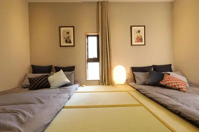 a living room with two beds and a window at Shinjuku Gyoen house 2LDK in Tokyo