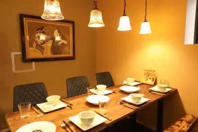a dining room with a long table with chairs and lights at Shinjuku Gyoen house 2LDK in Tokyo
