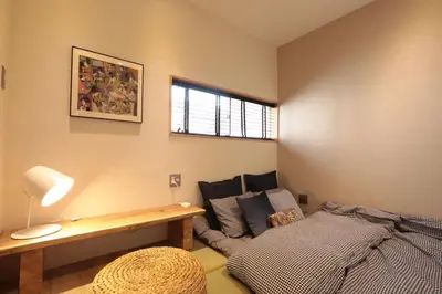 a living room with a bed and a couch at Shinjuku Gyoen house 2LDK in Tokyo