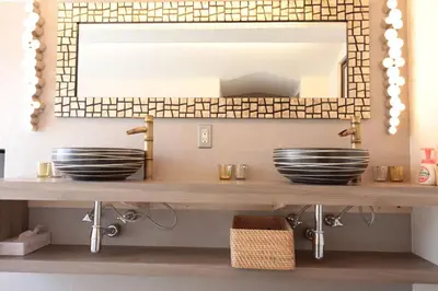 a bathroom sink with a mirror and bowls on a shelf at Shinjuku Gyoen house 2LDK in Tokyo