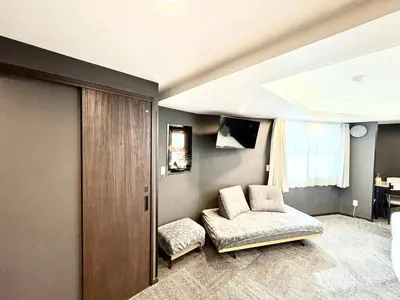 a room with a bed and a couch and a window at Oji\u6b63\u548c\u30d3\u30eb in Tokyo
