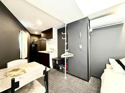 a room with a bed and a table in it at Oji\u6b63\u548c\u30d3\u30eb in Tokyo