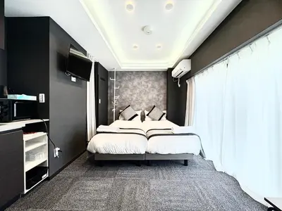 a bedroom with a bed and a large window at Oji\u6b63\u548c\u30d3\u30eb in Tokyo