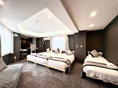 a bedroom with three beds in a room at Oji\u6b63\u548c\u30d3\u30eb in Tokyo