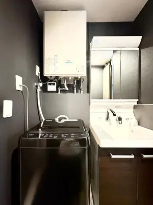 a kitchen with a black refrigerator and a sink at Oji\u6b63\u548c\u30d3\u30eb in Tokyo