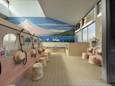 a bathroom with a painting of a mountain on the wall at OMATSURI BASE Nakanoshimbashi in Tokyo