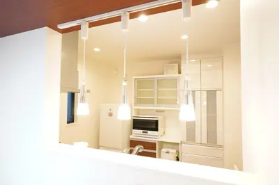 a kitchen with white cabinets and a mirror at Chihaya house \u5343\u65e9\u30cf\u30a6\u30b9 in Tokyo