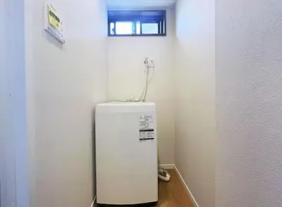 a white refrigerator in a corner of a room at \u677e\u5c4b\u30db\u30c6\u30eb4\u968e in Tokyo