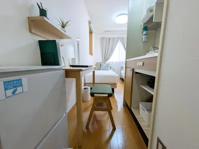 a small room with a desk and a bed at Laze Nakano 2bed Travel Work Broadway in Tokyo
