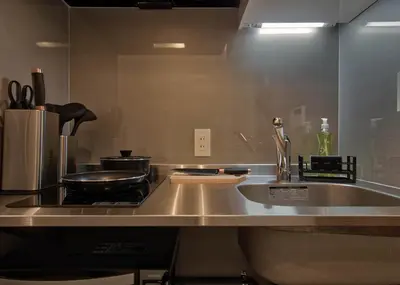 a kitchen counter with a stove and a sink at STUMP SA Shibuya Shoto in Tokyo