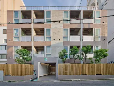 an apartment building with a parking garage in front of it at STUMP SA Shibuya Shoto in Tokyo