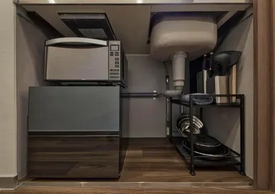 a kitchen with a sink and a microwave at STUMP SA Shibuya Shoto in Tokyo