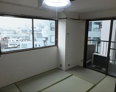 an empty room with large windows and a view of a city at Shinjuku Okubo House close to Kabukicho in Tokyo