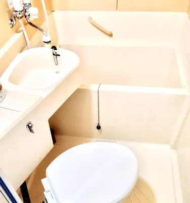 a small bathroom with a toilet and a sink at Shinjuku Okubo House close to Kabukicho in Tokyo