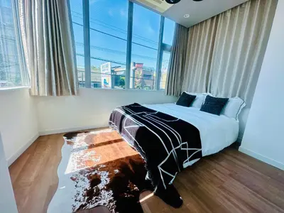 a bedroom with a bed and a large window at Miyazaki in Tokyo