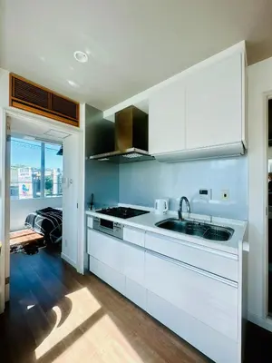 a kitchen with white cabinets and a sink at Miyazaki in Tokyo
