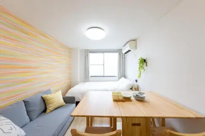 a living room with a couch and a table at Minamishinagawa A-yokocho Base in Tokyo